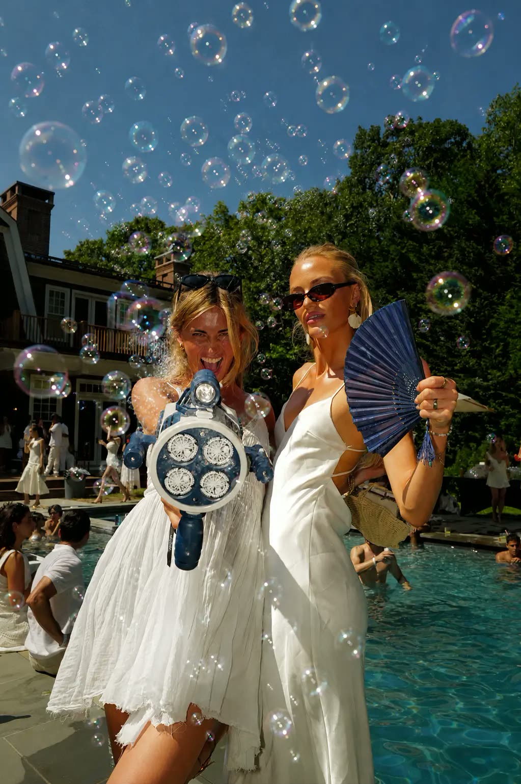 Guests poolside amid bubbles at the Southampton white party