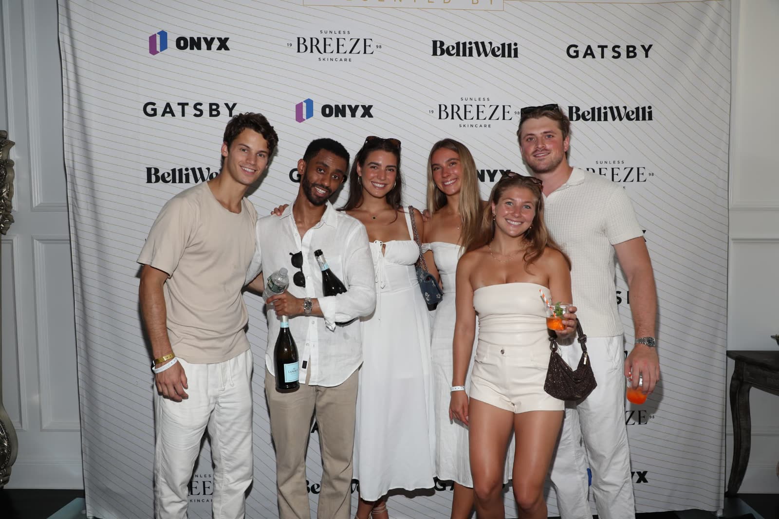 Group of guests on the sponsor step-and-repeat